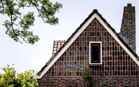 Een bordje met de tekst ‘Home shake home’ aan een woning in het Groningse dorp Overschild.
