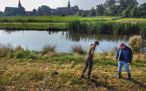 Stefan Olie (r) en Jan Nutma inspecteren een veendijk in de Van Ommenpolder bij Heeg, 16 augustus 2022. 