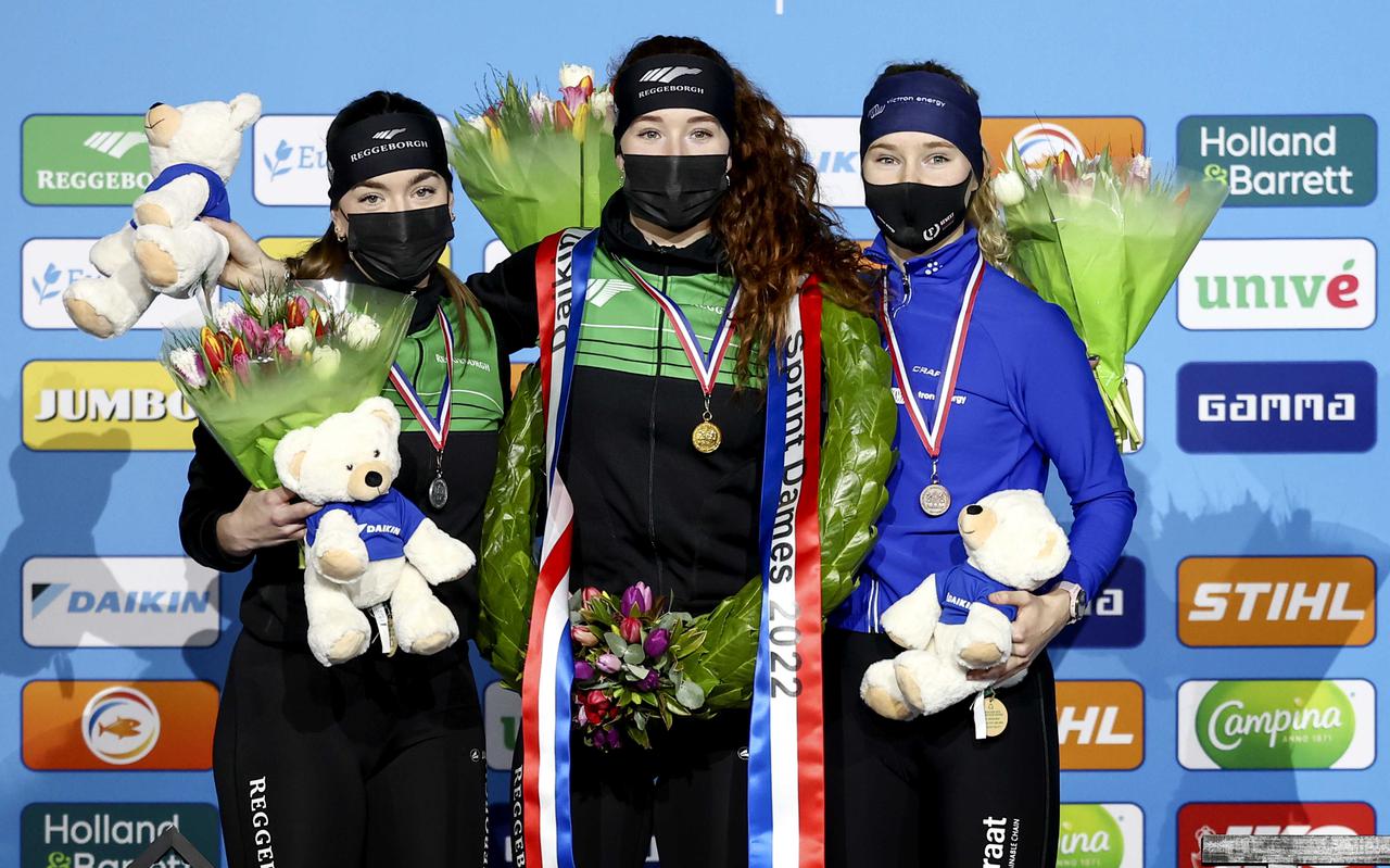 Ien, twa, trije op Thialf na het NK sprint. Winnares Michelle de Jong (m) weet zich op het podium geflankeerd door Marrit Fledderus (l) en Helga Drost.