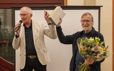 Schrijver Wim Aalbers krijgt de prijs uitgereikt van wethouder Jan Dijkstra.