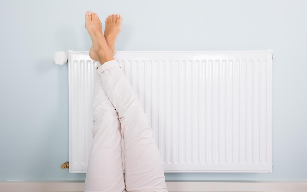 De voeten op de radiator voor warme voeten. De voeten op de radiator voor warme voeten.