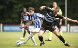 Jan Ras (l) schermt de bal af in de oefenwedstrijd van sc Heerenveen tegen KV Kortrijk.
