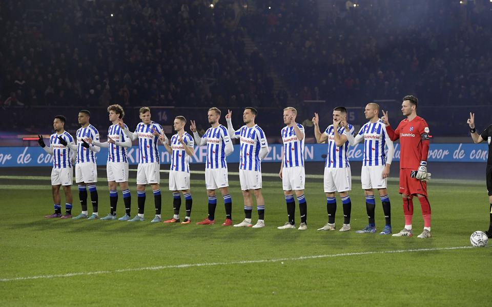 Spelers van sc Heerenveen maken een v-teken voor aanvang van de Nederlandse eredivisiewedstrijd tegen FC Utrecht. 